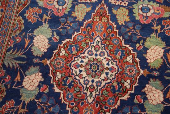 A Kashan blue ground rug, 6ft 8in by 4ft 5in.
